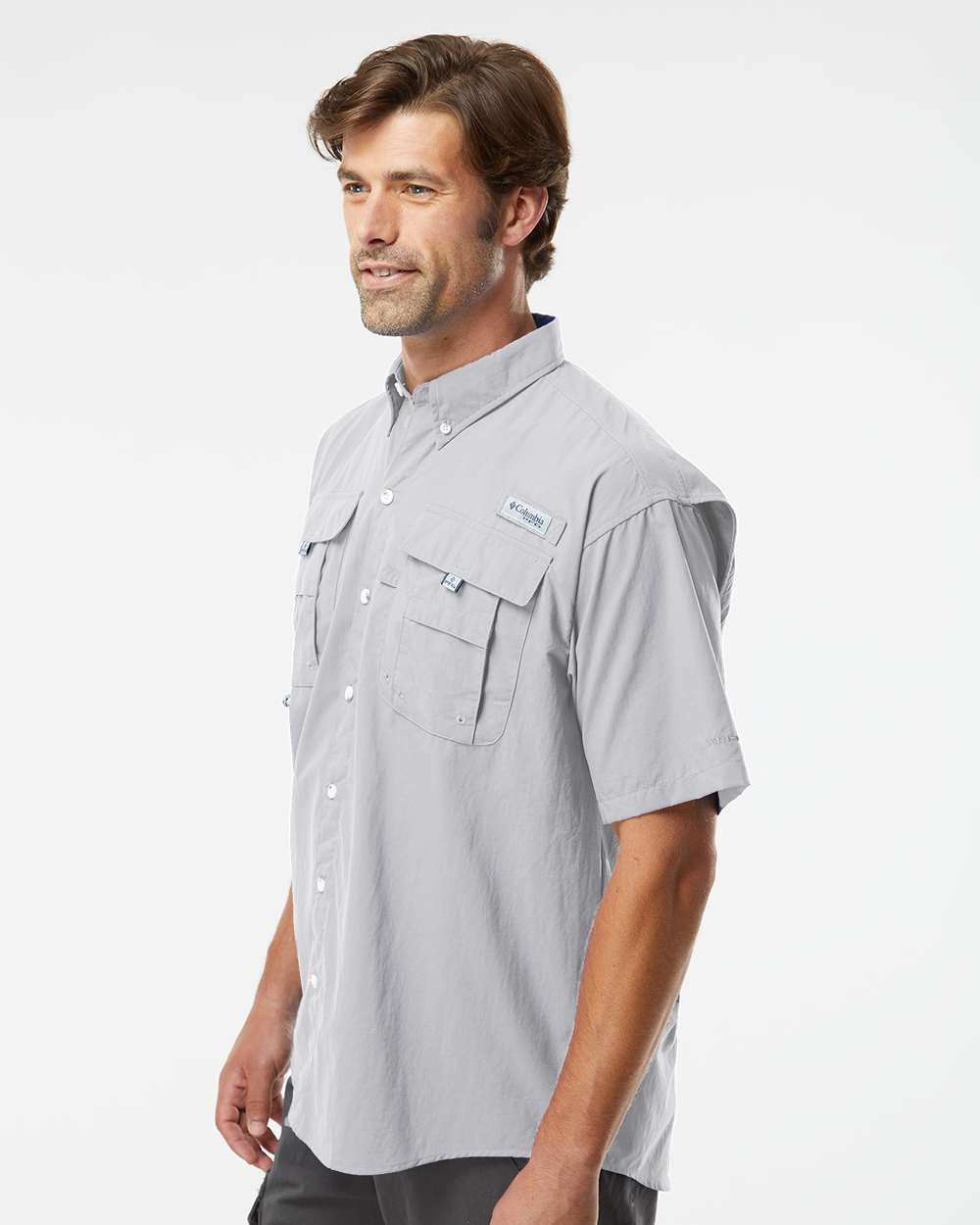 Man wearing a gray short-sleeve shirt with a brand logo on a white background