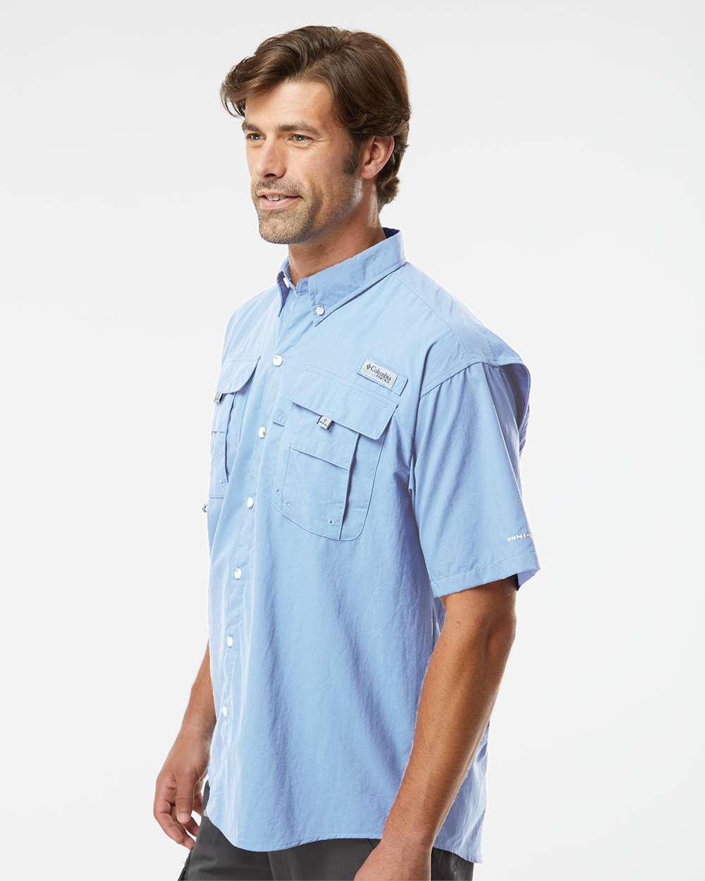 Man wearing a light blue short-sleeve shirt on a white background