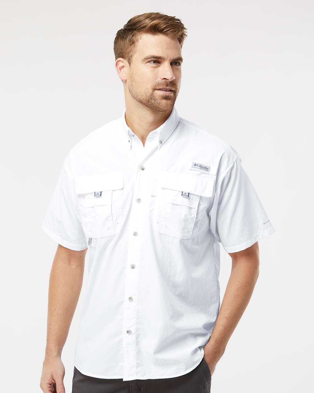 Man wearing a white short-sleeve button-up shirt on a white background