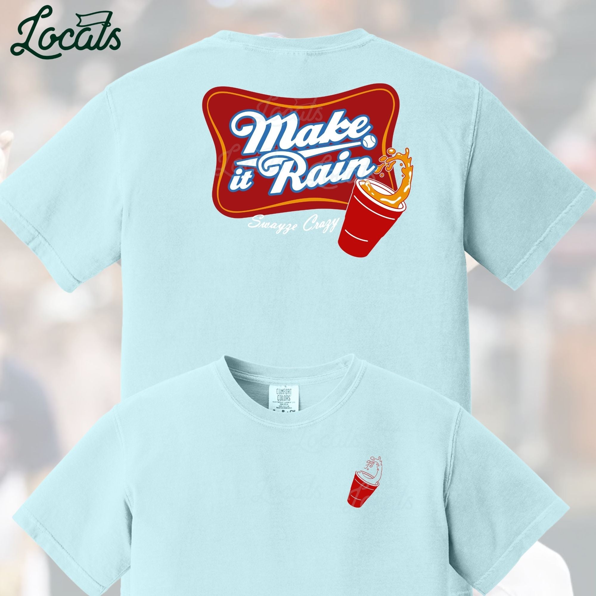 Light blue t-shirt with 'Make it Rain' graphic on the back, displayed against a blurred background.