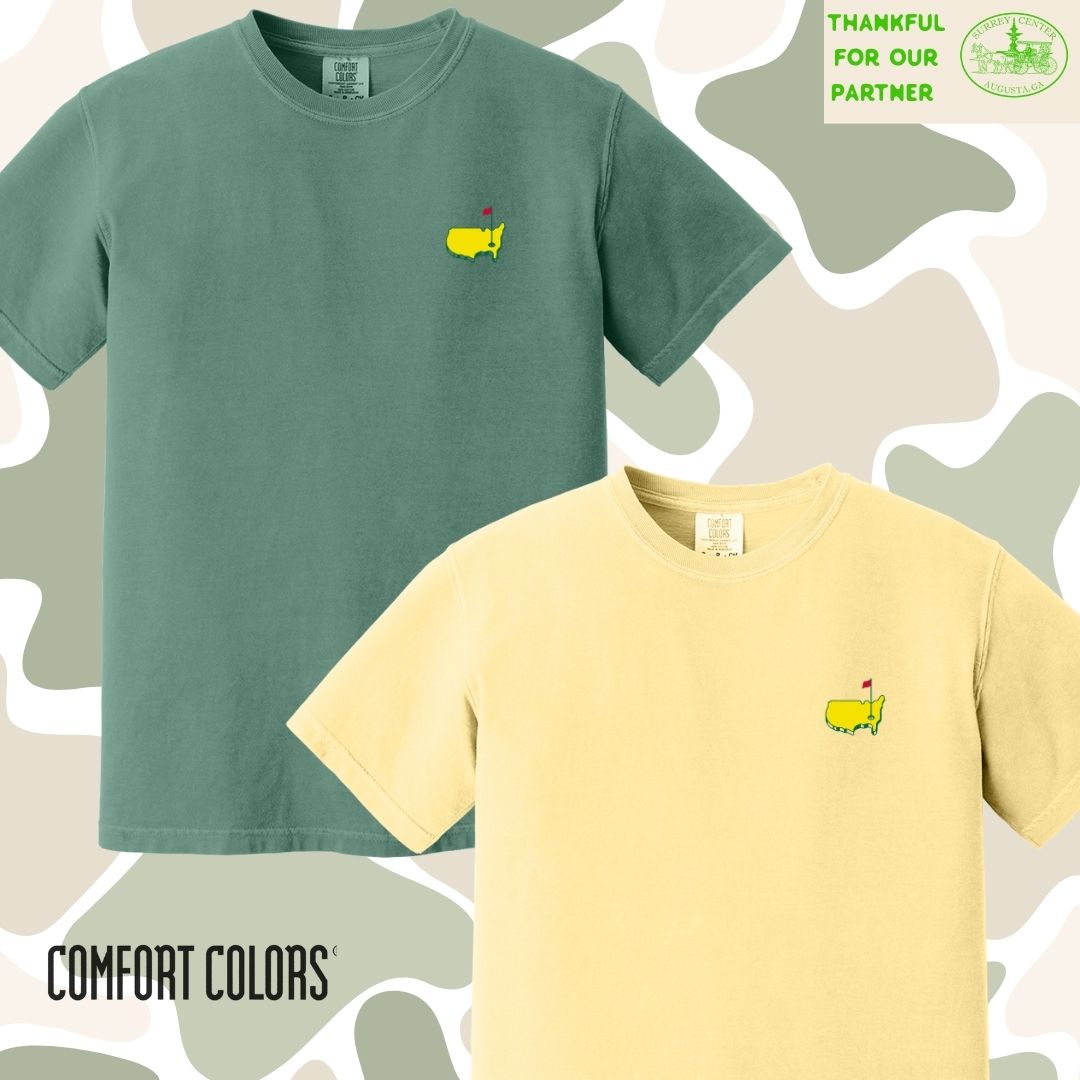 Two t-shirts, one green and one yellow, with a small logo on a patterned background. Comfort Colors branding is visible.